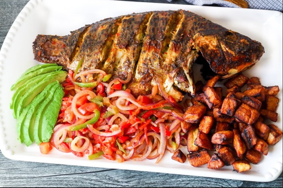 African roasted fish with fried plantains and salad